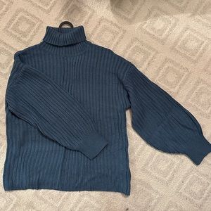 Blue turtleneck knit sweater with bell sleeves